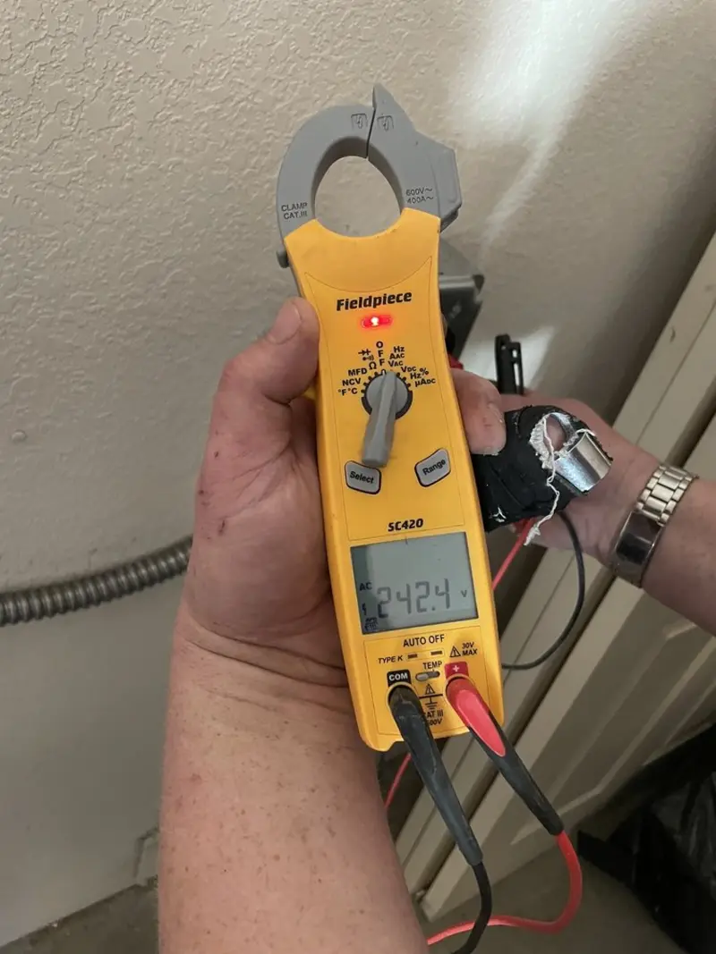 Voltage testing with clamp meter during Electrical Installation Services in Hayden